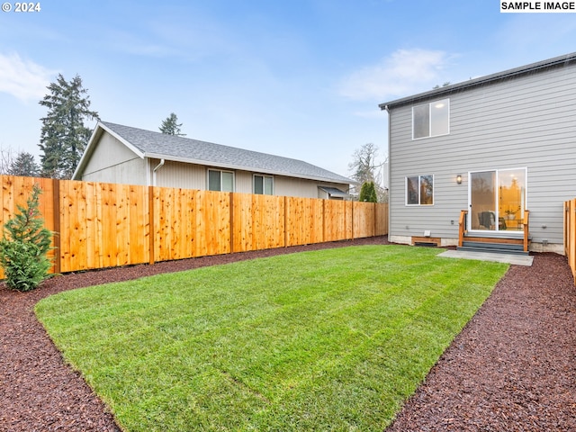 view of yard with a fenced backyard