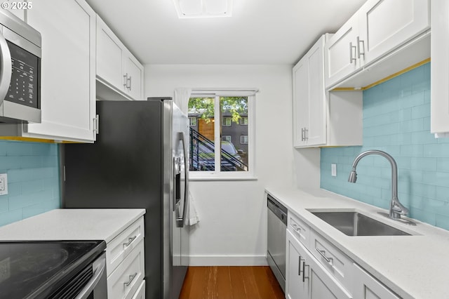12622 NW Barnes Rd Unit 6, Portland, OR 97229 - kitchen featuring a sink, appliances with stainless steel finishes, baseboards, light countertops, and dark wood-style flooring
