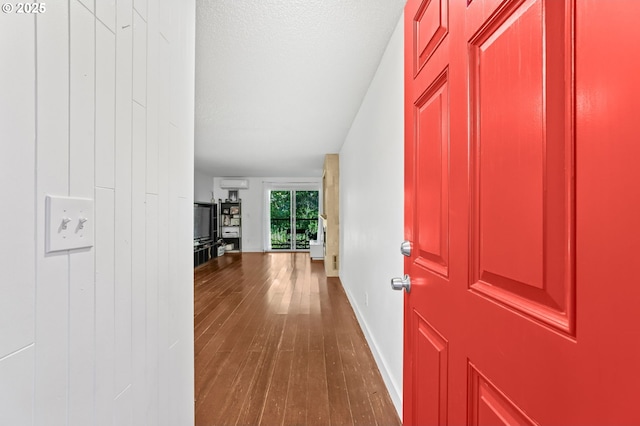 12622 NW Barnes Rd Unit 6, Portland, OR 97229 - entryway with wood finished floors, a wall mounted AC, and baseboards
