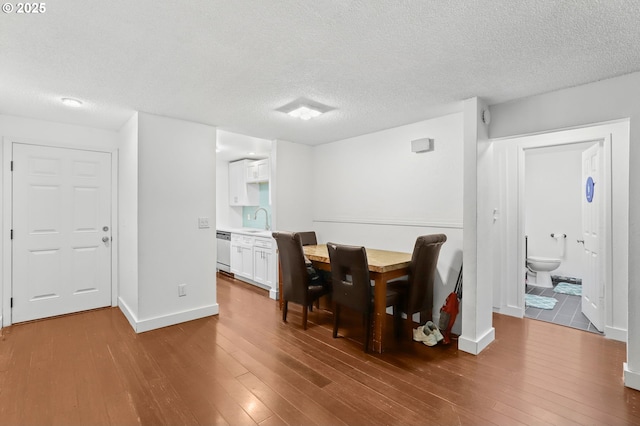 12622 NW Barnes Rd Unit 6, Portland, OR 97229 - dining area featuring wood finished floors, a textured ceiling, and baseboards
