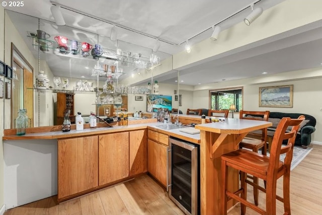 370 Wild Fern Dr, Winchester, OR 97495 - indoor wet bar with wine cooler, light wood finished floors, and track lighting