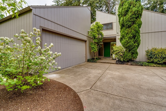 mid-century home with an attached garage and concrete driveway