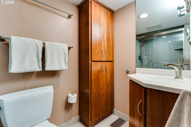 bathroom with visible vents, a stall shower, vanity, baseboards, and toilet
