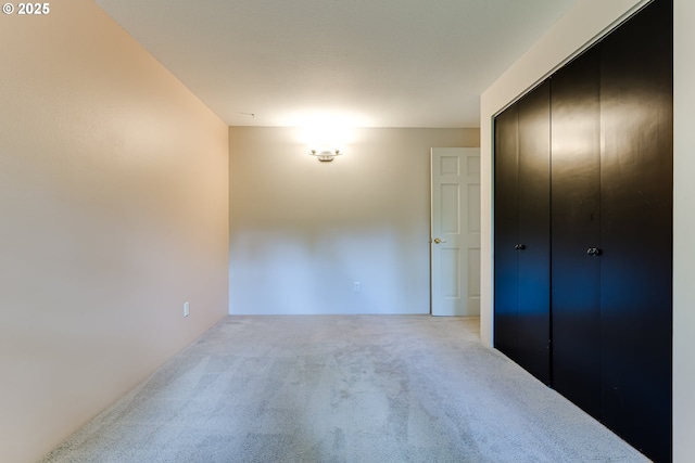 unfurnished bedroom with carpet and a closet