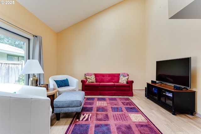 living room with vaulted ceiling and wood finished floors