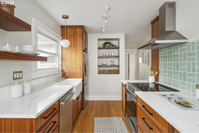 3737 NE 74th Ave, Portland, OR 97213 - kitchen featuring wall chimney exhaust hood, open shelves, stainless steel appliances, a sink, and brown cabinetry