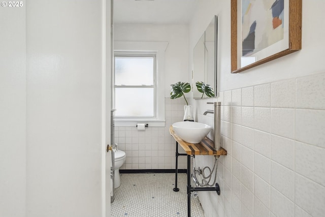 3737 NE 74th Ave, Portland, OR 97213 - half bathroom featuring tile walls, a sink, tile patterned floors, toilet, and a wainscoted wall