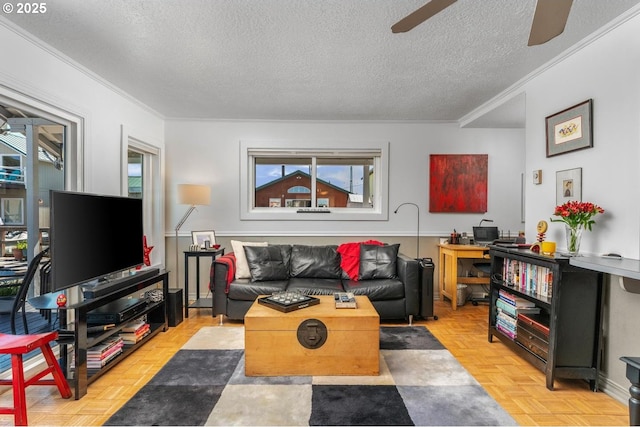 living room featuring a textured ceiling, light parquet floors, ceiling fan, and crown molding