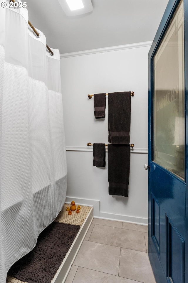 bathroom with tile patterned floors, curtained shower, and crown molding