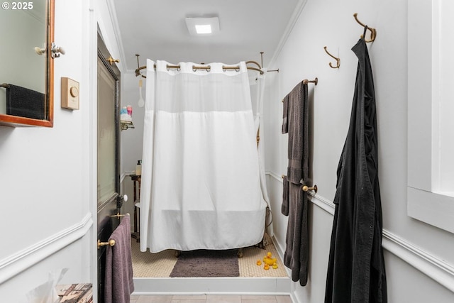 bathroom with tile patterned floors, a shower with shower curtain, and ornamental molding