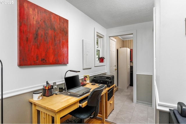 home office with light tile patterned floors and a textured ceiling