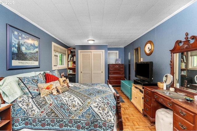 bedroom featuring a closet, light parquet floors, and ornamental molding