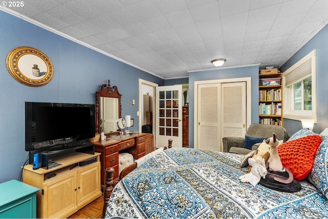 bedroom with parquet floors, a closet, and crown molding