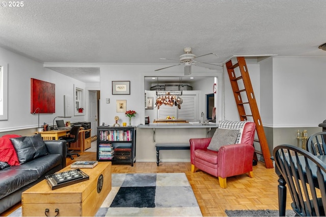 living room featuring a textured ceiling, light parquet flooring, ceiling fan, and sink