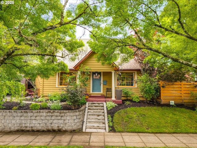view of front of house with fence and a porch