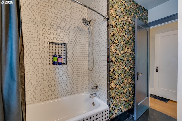 full bathroom featuring washtub / shower combination, baseboards, and wallpapered walls