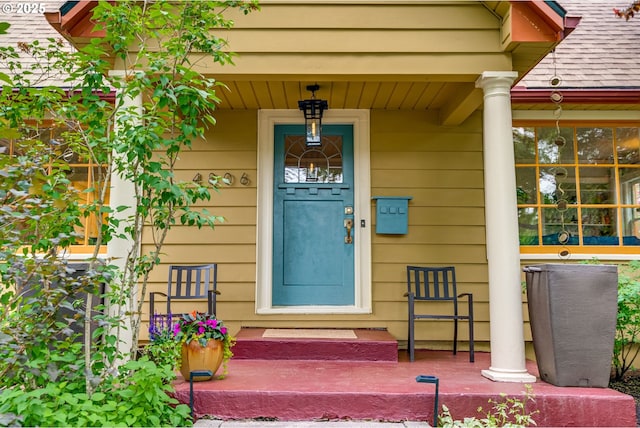 view of exterior entry featuring covered porch