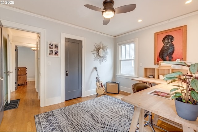 home office featuring baseboards, crown molding, light wood-type flooring, a ceiling fan, and recessed lighting