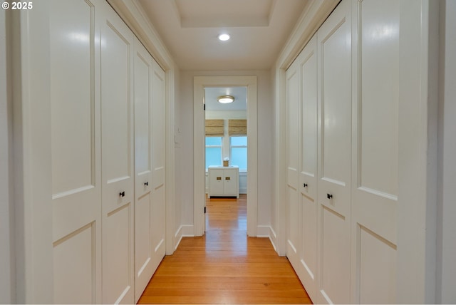 hallway featuring light wood finished floors and recessed lighting