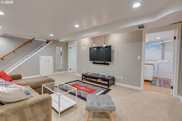 living area featuring washing machine and dryer, light colored carpet, recessed lighting, stairway, and baseboards
