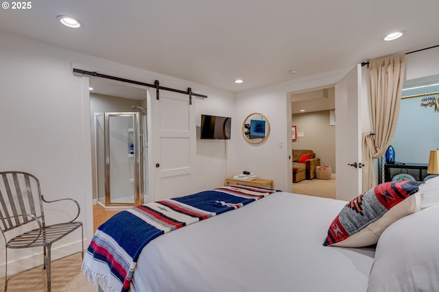 bedroom with a barn door, carpet flooring, and recessed lighting