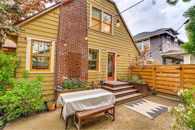 back of house with fence and a patio