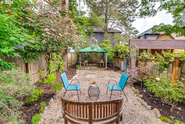 view of patio / terrace featuring a gazebo and a fenced backyard