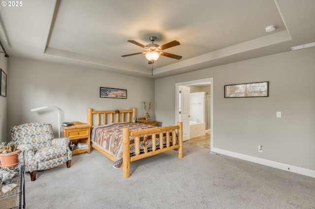10380 SW Madrid Loop, Wilsonville, OR 97070 - carpeted bedroom featuring a tray ceiling, ceiling fan, and ensuite bathroom