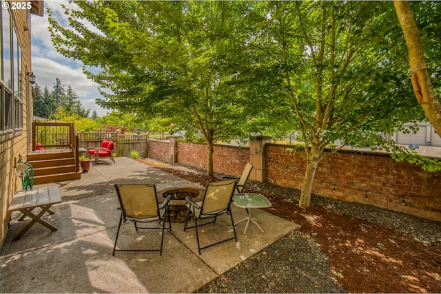 10380 SW Madrid Loop, Wilsonville, OR 97070 - fenced backyard featuring an outdoor fire pit, a patio, and a deck