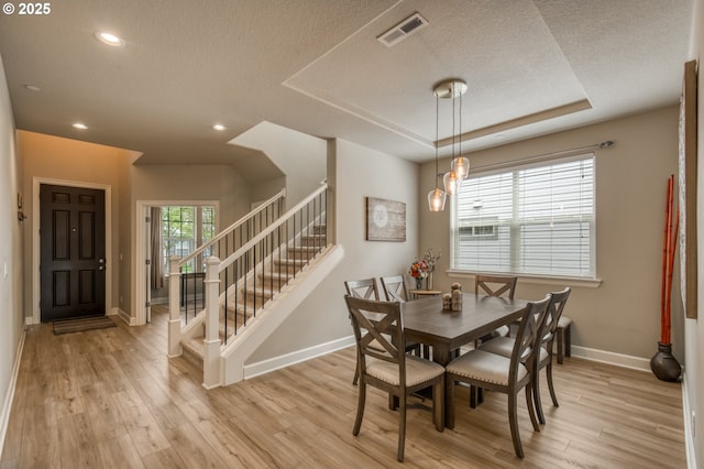 10380 SW Madrid Loop, Wilsonville, OR 97070 - dining space with a textured ceiling, light wood-type flooring, stairs, and recessed lighting