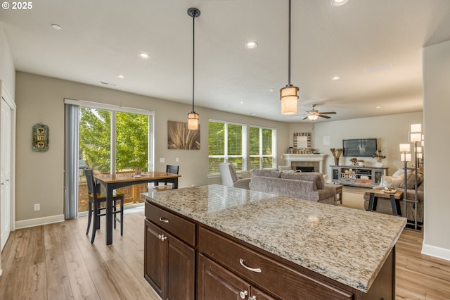 10380 SW Madrid Loop, Wilsonville, OR 97070 - kitchen featuring light wood-type flooring, a ceiling fan, healthy amount of natural light, recessed lighting, and decorative light fixtures
