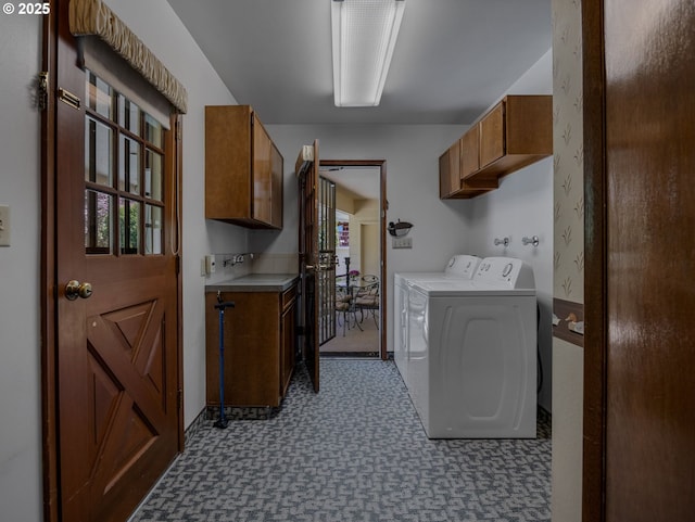 laundry room with tile patterned floors, cabinet space, and washer and clothes dryer