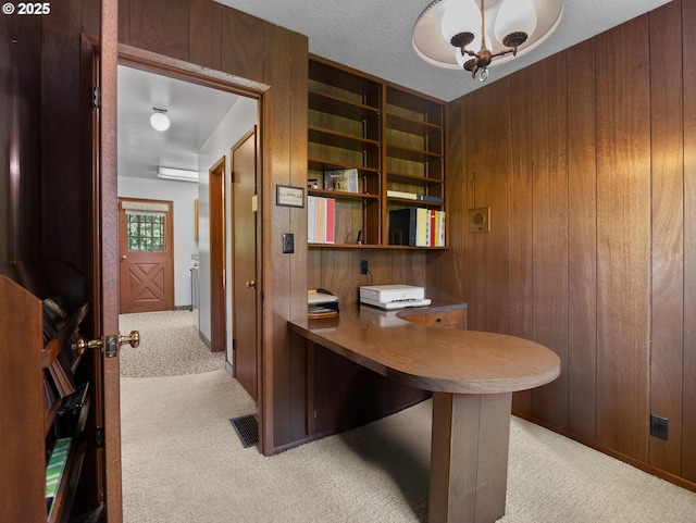 home office featuring wood walls and light carpet
