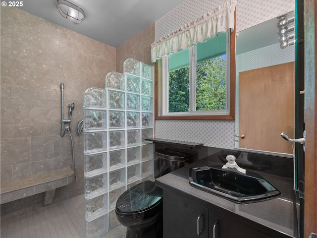 full bathroom with vanity, a walk in shower, and toilet