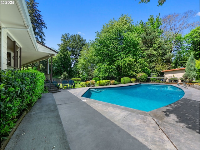 view of swimming pool featuring fence, a patio area, and a fenced in pool
