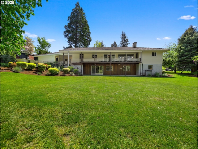 rear view of property with a yard and a chimney