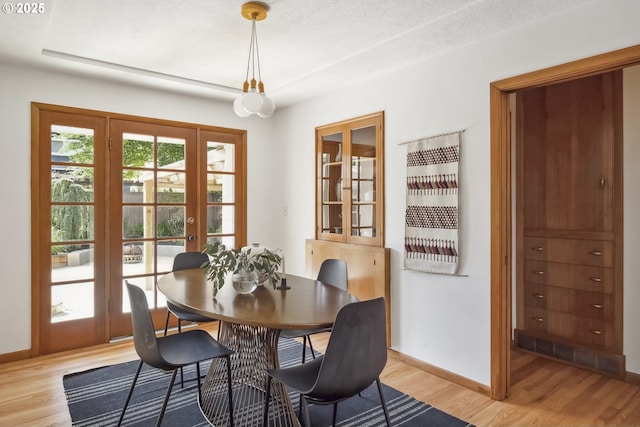 7625 N Fowler Ave, Portland, OR 97217 - dining room with light wood-style floors, baseboards, and french doors