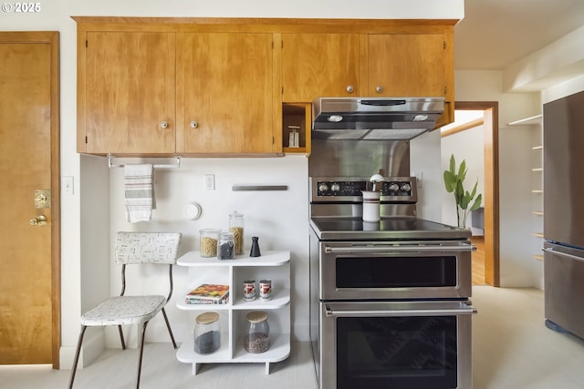 7625 N Fowler Ave, Portland, OR 97217 - kitchen featuring stainless steel appliances, under cabinet range hood, and brown cabinets