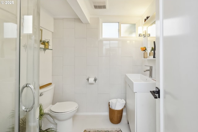 7625 N Fowler Ave, Portland, OR 97217 - bathroom featuring vanity, toilet, a shower with door, and tile patterned floors