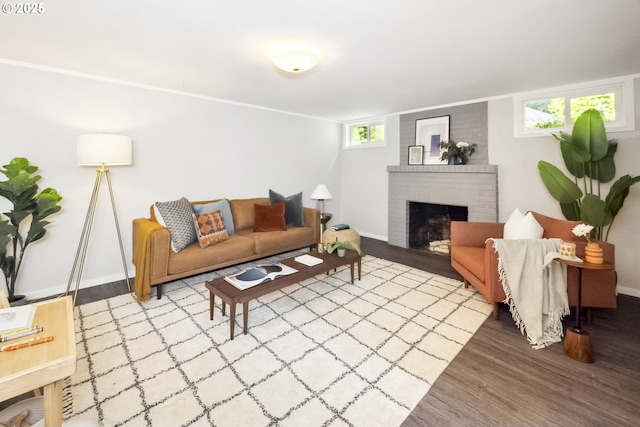 7625 N Fowler Ave, Portland, OR 97217 - living area featuring wood finished floors, a brick fireplace, and baseboards
