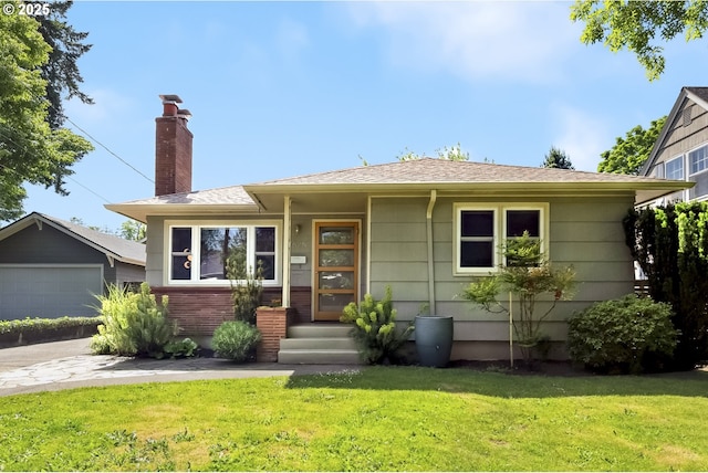 7625 N Fowler Ave, Portland, OR 97217 - view of front of home with a front lawn, a garage, a chimney, and roof with shingles