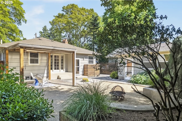 7625 N Fowler Ave, Portland, OR 97217 - rear view of house with a fire pit, a patio, and a chimney