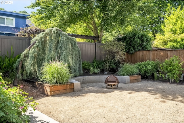 7625 N Fowler Ave, Portland, OR 97217 - fenced backyard featuring a patio and an outdoor fire pit