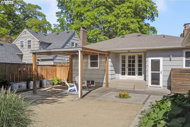 7625 N Fowler Ave, Portland, OR 97217 - back of property with a patio, a chimney, and roof with shingles