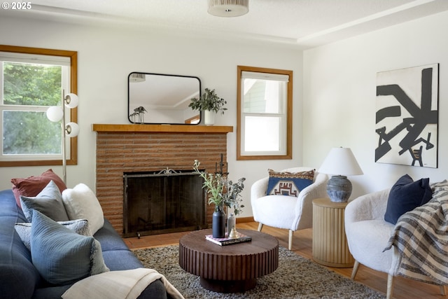 7625 N Fowler Ave, Portland, OR 97217 - living area featuring wood finished floors and a brick fireplace