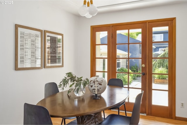 7625 N Fowler Ave, Portland, OR 97217 - dining space featuring french doors, light wood finished floors, and a chandelier