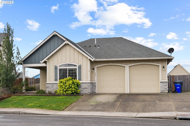 view of front of home featuring concrete driveway, a shingled roof, stone siding, and fence