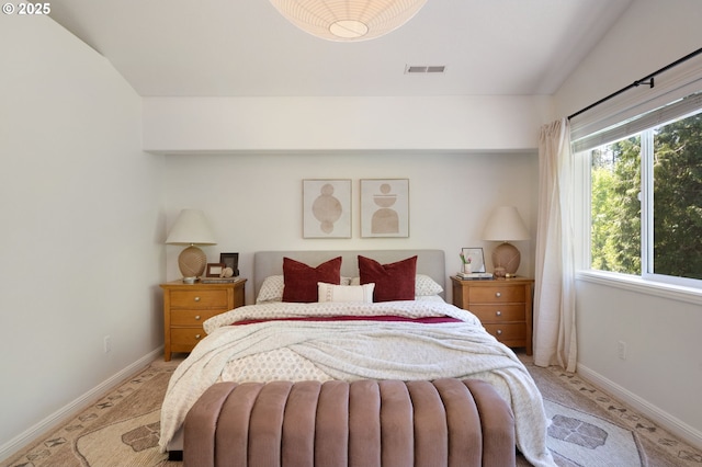 bedroom featuring baseboards and light carpet