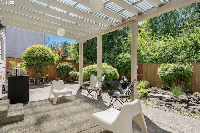 view of patio / terrace with a fenced backyard and a pergola