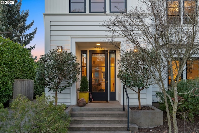 view of exterior entry at dusk